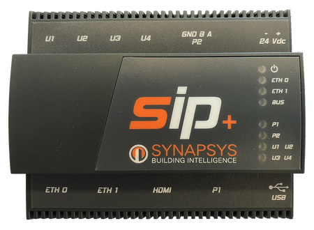 A Synapssys SIP+ DAIKIN Building Intelligence electrical module in black plastic, featuring orange and white branding, terminal labels, and LED status indicators.